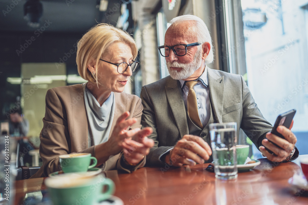 Happy Senior Couple Enjoying Digital Connection use smartphone at Cafe Happy Senior Couple Enjoying Digital Connection use smartphone at Cafe