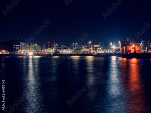 Illuminated at night Galway city port. Dockland area. Lights reflection in water. Night life. Town street with lights. West of Ireland. © mark_gusev