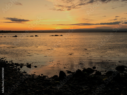 Silhouette of a rough coastline at sunrise. Warm and cool color. Nobody. Stunning nature scene. Galway bay  Ireland.