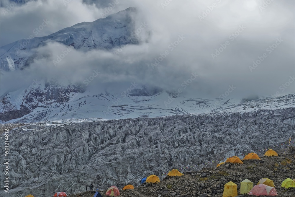 Colorful expedition tents stand at Manaslu Base Camp with the majestic