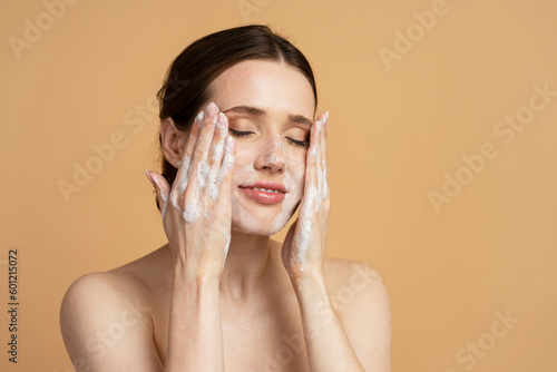 Bild auf Leinwand Young woman 20-30 years old, with cleansing soap foam or makeup remover on hands