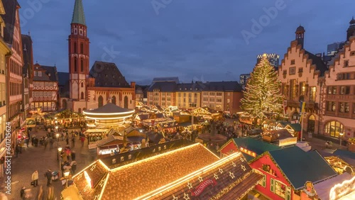 People at busy Christmas Market in Romerberg Square at dusk, Frankfurt am Main, Hesse photo