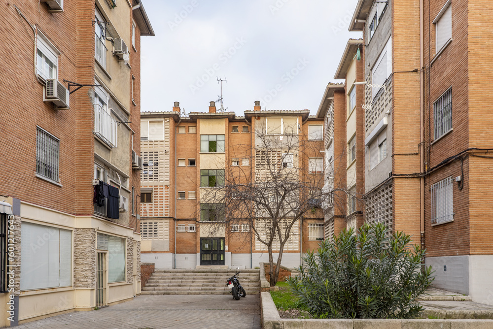 Obraz premium View of facades of residential buildings with gardens, stone stairs, business