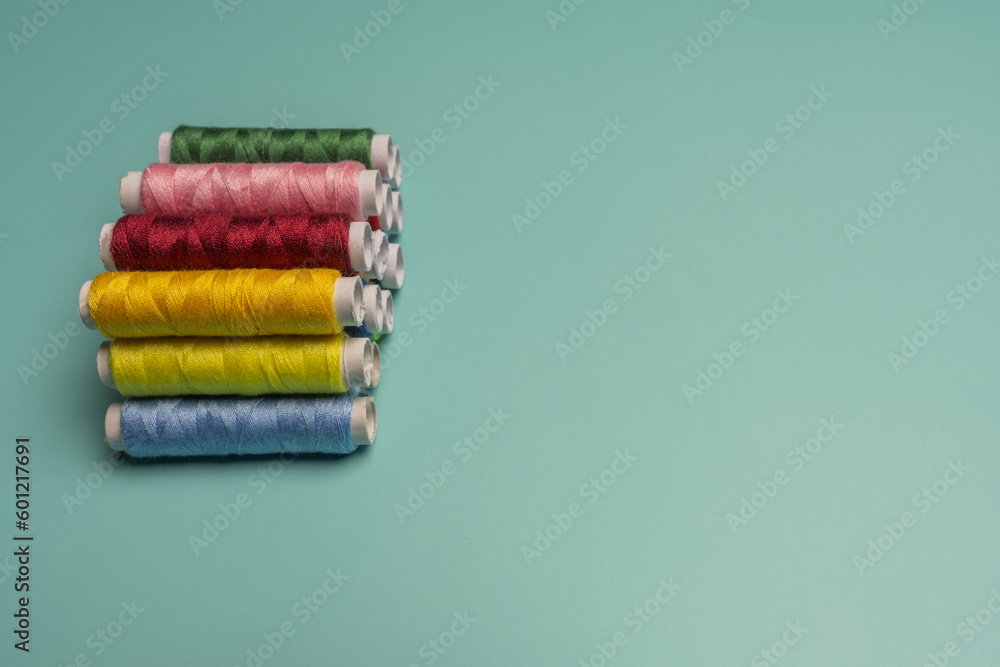 Spools of multi colored sewing thread stacked Spools of multi colored sewing thread stacked