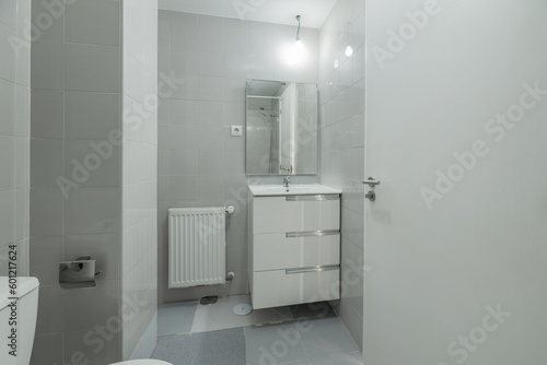  A simple wardrobe with a small white wooden cabinet with drawers below