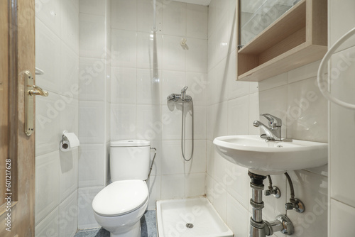 A simple toilet with a small shower tray, white porcelain toilets
