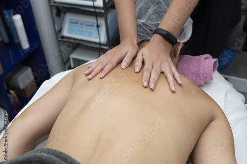 Applying a massage to the back of a patient
