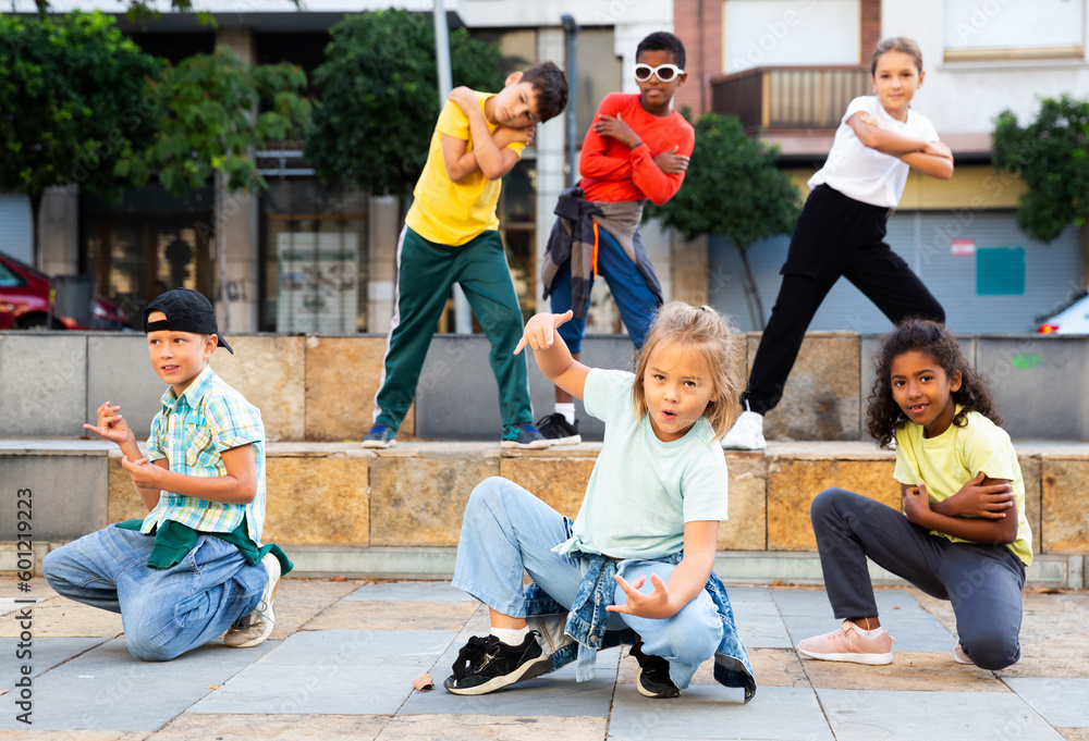 Fototapeta premium Modern tweens dancing on summer street. Urban lifestyle. Hip-hop generation