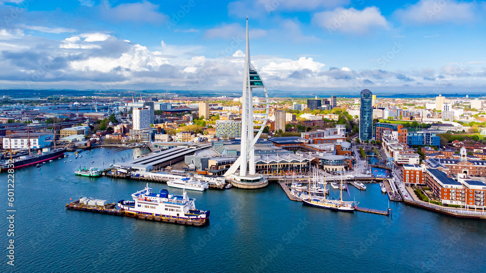 Naklejka premium Aerial view of the sail-shaped Spinnaker Tower in Portsmouth Harbor in the south of England on the Channel coast - Gunwharf Quays modern shopping mall in a residential waterfront area