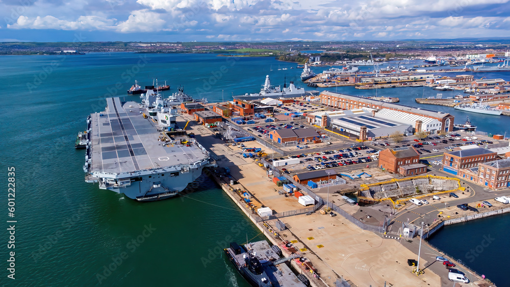 Aerial view of an aircraft carrier of the Royal Navy moored in Portsmouth Harbour on the English Channel coast in the south of England, United Kingdom