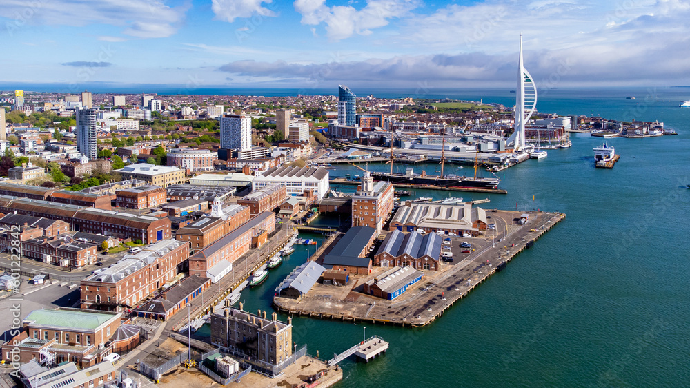 Aerial view of Portsmouth Historic Dockyard and the Royal Navy's ancient HMS Warrior warship as well as the Spinnaker Tower on the English Channel coast in the south of England, United Kingdom