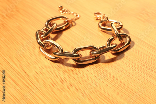 Beautiful chain bracelet on wooden background