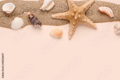 Sand with seashells and starfishes on pale pink background