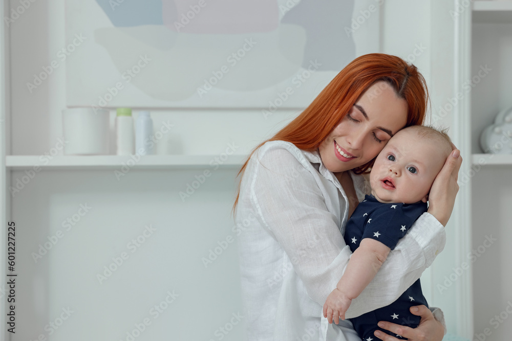 Mother with her cute baby at home, space for text Mother with her cute baby at home, space for text