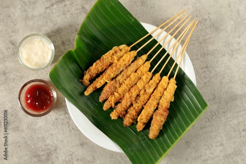 Telur Gulung, Rolled Egg with Skewers. Popular Street Food in Indonesia photo