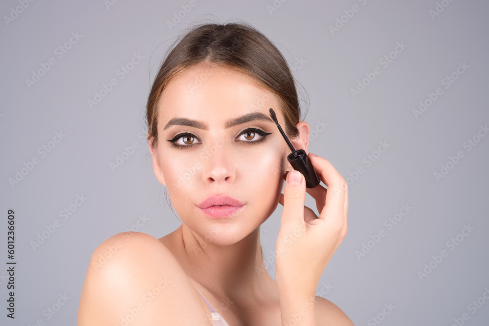 Woman comb eyebrows with eyebrow brush. Care for brows, eyebrows lamination. Brow beauty procedures. Beautiful woman with long eyelashes, eyebrows. Woman comb eyebrows with eyebrow brush. Care for brows, eyebrows lamination. Brow beauty procedures. Beautiful woman with long eyelashes, eyebrows.