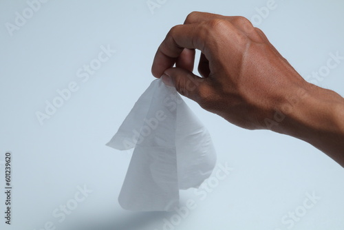 hand holding tissue on isolated white background