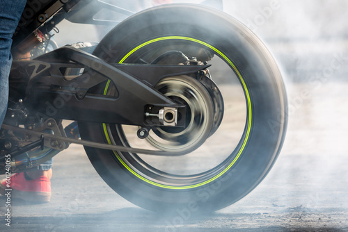 Canvastavla Motorbike burning tire rubber on road, Motorbike wheel drifting and white smoking on track, Motorcycle wheel on racing track with white smoke