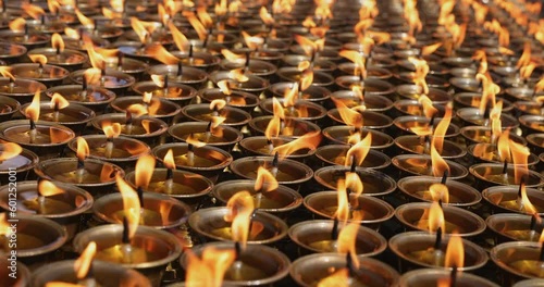 Rows of candles flickering slowly in a monastery in Nepal. photo