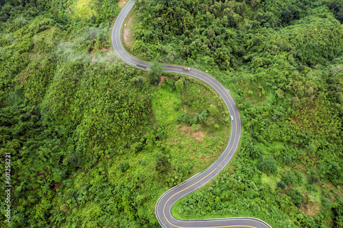 Top view of countryside road passing through the green forrest and mountain © freedom_naruk
