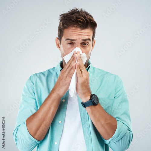 Papier peint Sick, tissue and portrait of man blowing nose in studio with flu, illness and virus on white background