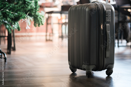 Large suitcases stand in the lobby of the hotel on the background.