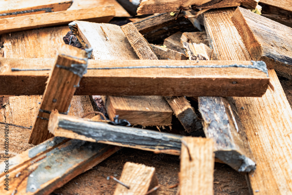 Construction waste after dismantling the formwork of a reinforced concrete foundation. Utilization of construction waste. Old boards, beams and formwork panels at a construction site. Construction waste after dismantling the formwork of a reinforced concrete foundation. Utilization of construction waste. Old boards, beams and formwork panels at a construction site.