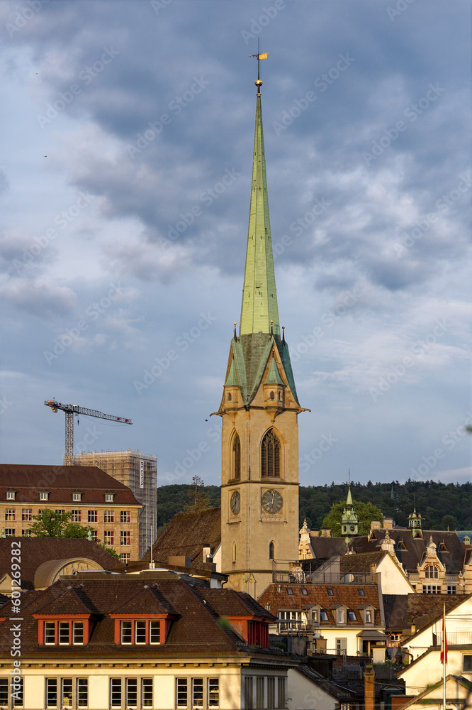 Scenic view of the old town of Zürich with church tower of Preachers's Church on a cloudy spring evening. Photo taken May 6th, 2023, Zurich, Switzerland.