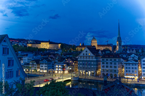 Aerial view over the old town of Zürich with Limmat River and city lights on a spring evening with dramatic sky. Photo taken May 6th, 2023, Zurich, Switzerland.