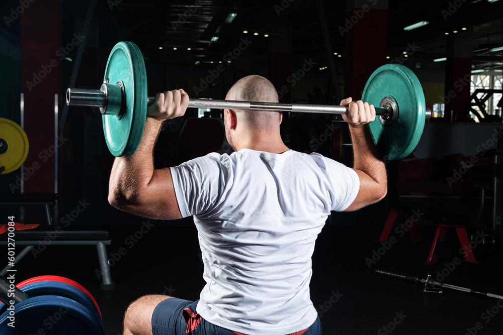 Male athlete lifts the barbell Male athlete lifts the barbell