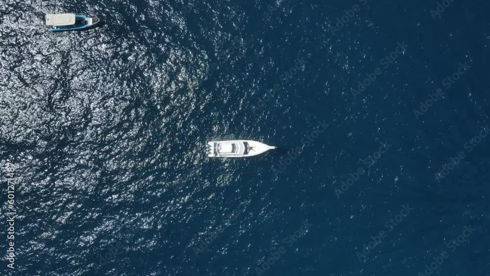 Top Down Aerial View of Yacht Boat Anchored in Deep Blue Water of Tropical Sea Top Down Aerial View of Yacht Boat Anchored in Deep Blue Water of Tropical Sea