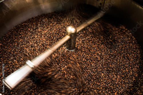 fresh coffee beans roasted spinning cover professional machine close up to soft focus slow shutter speed because want to make motion blur of coffee beans detail concept,