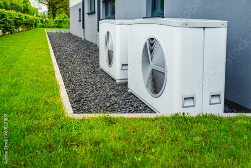 Fotografie, Obraz Two air source heat pumps installed outside of new and modern city house