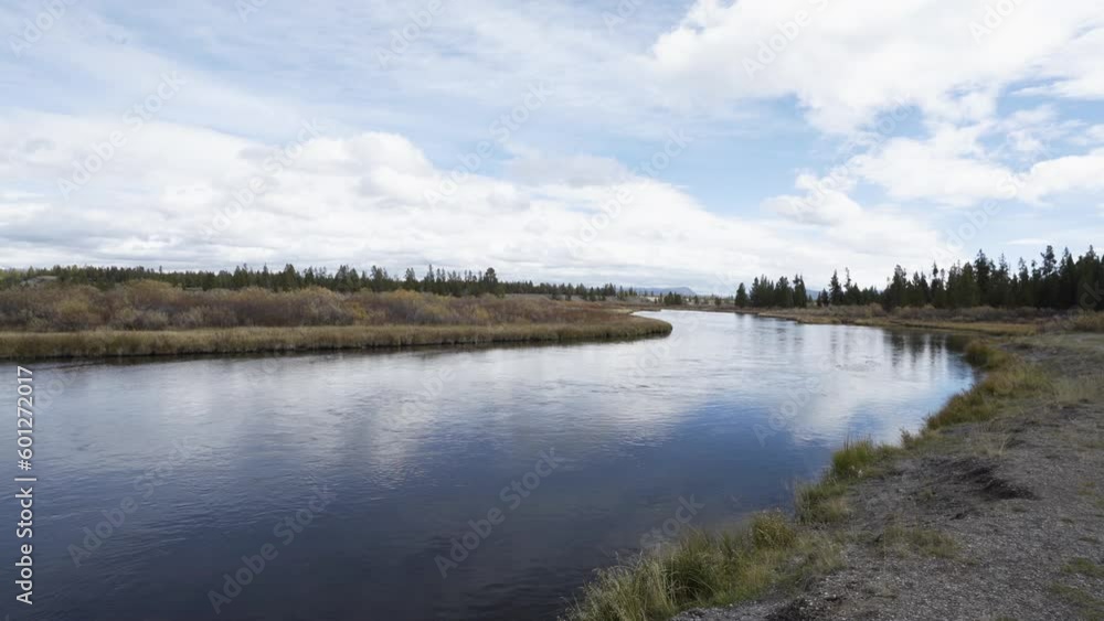 Wide of Madison river flowing calmly out of Yellowstone national Park in autumn Wide of Madison river flowing calmly out of Yellowstone national Park in autumn