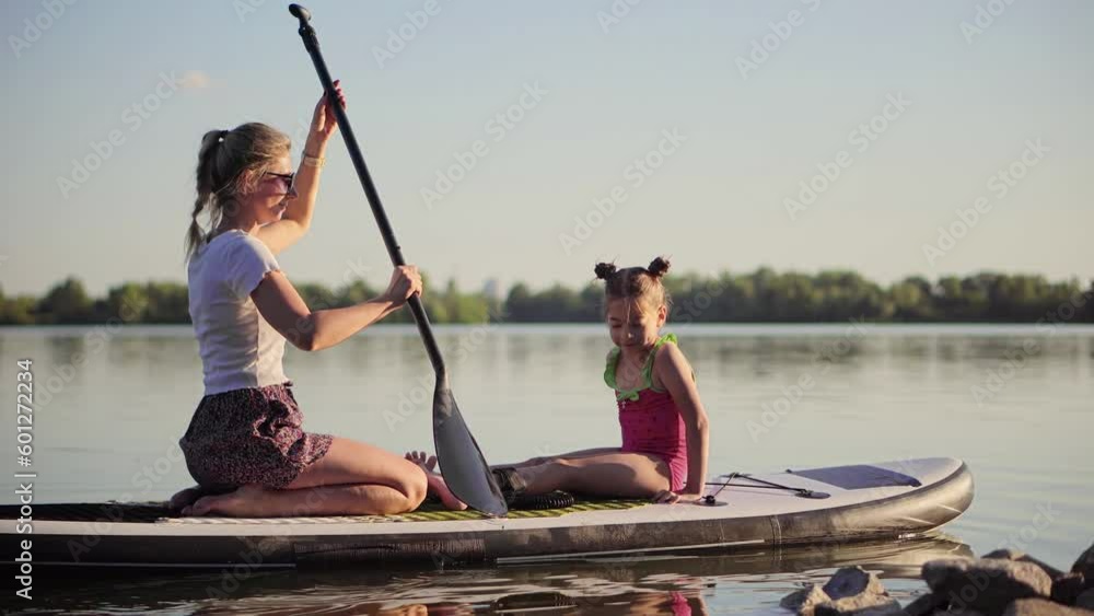 family using an inflatable board for rowing family using an inflatable board for rowing