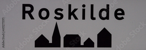 black and grey Roskilde sign