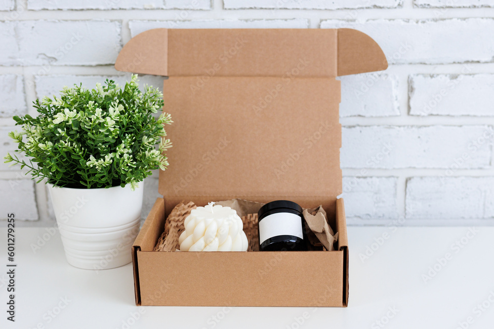 Fototapeta premium Aroma candles in a box and plant on table with copy space