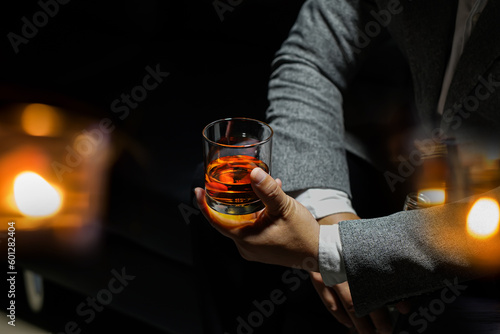 Closeup businessmen holding a glass of whiskey