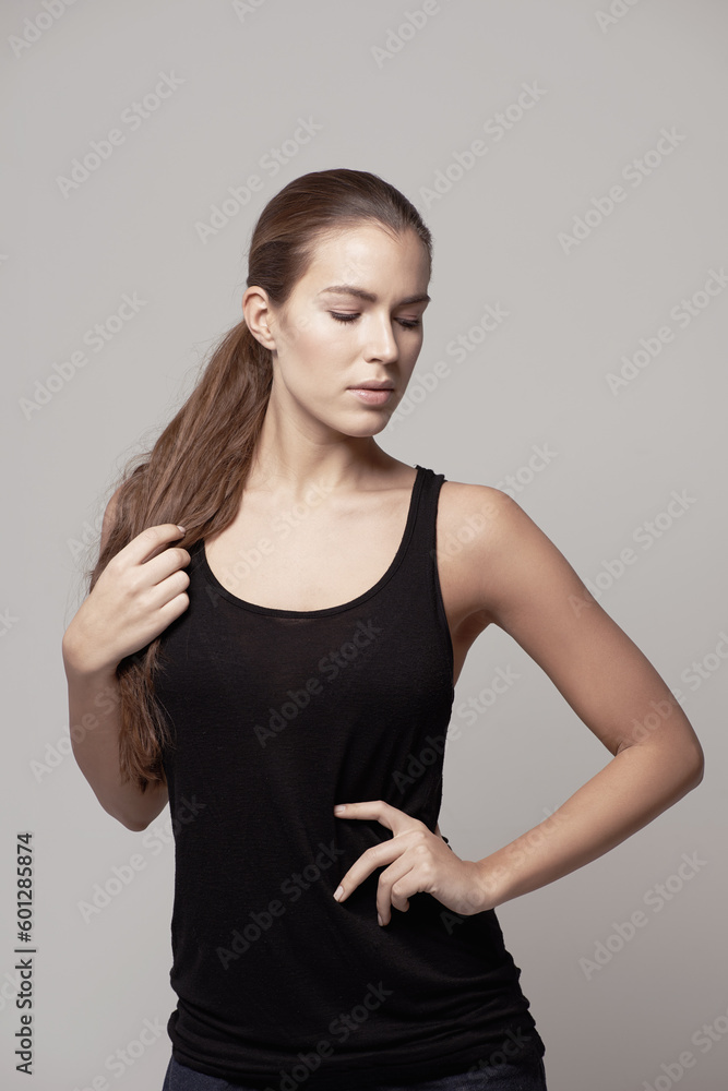 Woman, fitness and confidence for exercise, workout or training with sportswear against a gray studio background. Confident female person or model posing with slim and healthy body on backdrop Woman, fitness and confidence for exercise, workout or training with sportswear against a gray studio background. Confident female person or model posing with slim and healthy body on backdrop