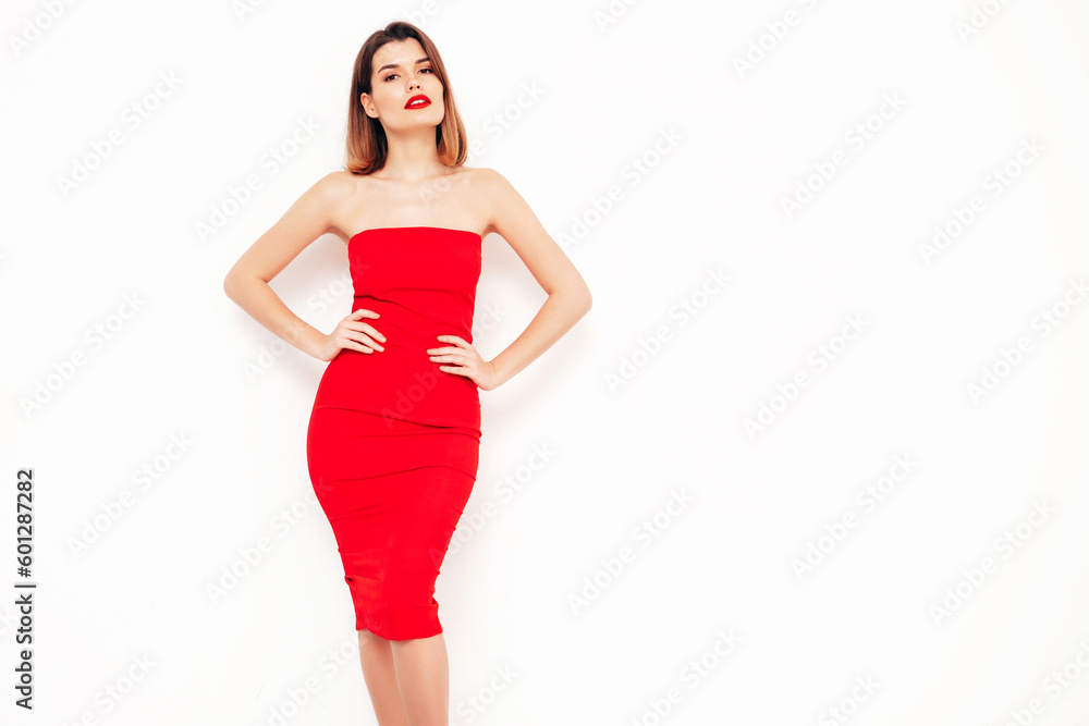 Young beautiful smiling female in trendy summer red evening dress. Sexy carefree brunette woman posing in studio, isolated on white. Positive model with evening makeup. Cheerful and happy Young beautiful smiling female in trendy summer red evening dress. Sexy carefree brunette woman posing in studio, isolated on white. Positive model with evening makeup. Cheerful and happy