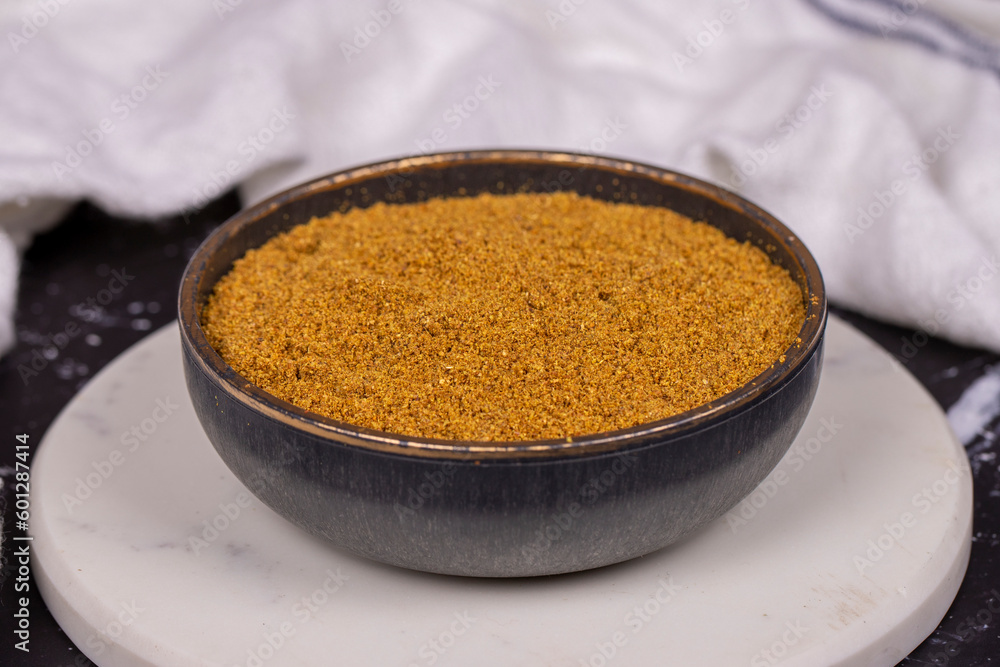 Cumin powder on dark background. spice or seasoning concept. Ground or sifted garam masala. indian spice. Close up Cumin powder on dark background. spice or seasoning concept. Ground or sifted garam masala. indian spice. Close up