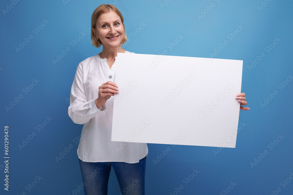 mature woman holding white sheet of paper for information with mocup mature woman holding white sheet of paper for information with mocup