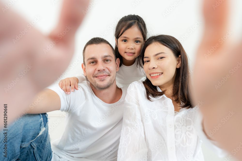 Happy family portrait with parents and little daughter.