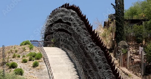 Daytime view of the fortified USA Mexico border wall as it runs through downtown Nogales, Arizona, USA. photo