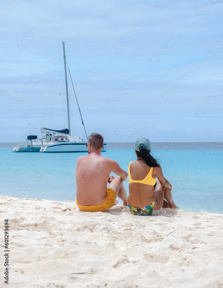 Fototapeta premium Klein Curacao Island with Tropical beach at the Caribbean island of Curacao Caribbean, a couple of men and women on a boat trip to Small Curacao Island 