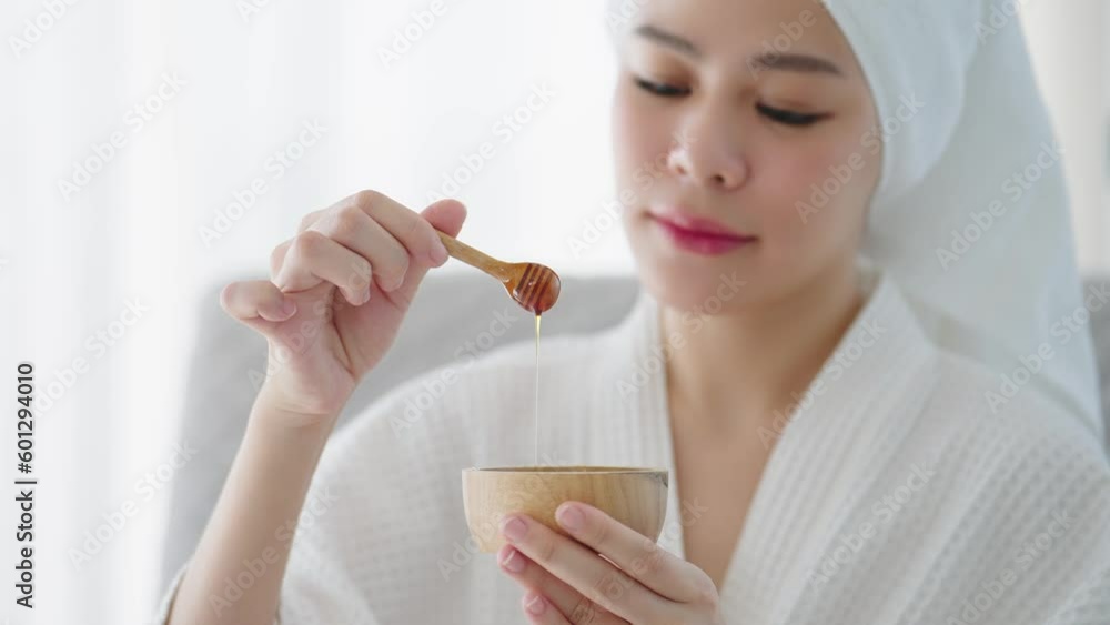 Close up beautiful asian women holding bowl of pure honey for spa therapy smiling to camera. Homemade face mask honey Close up beautiful asian women holding bowl of pure honey for spa therapy smiling to camera. Homemade face mask honey