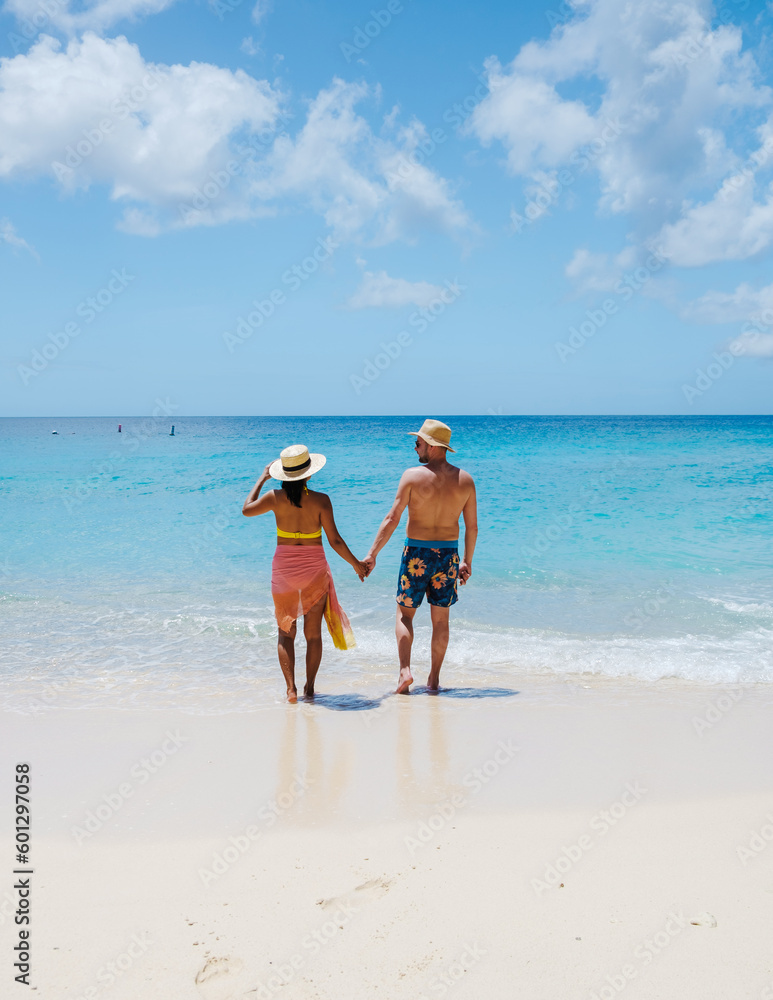 Grote Knip Beach Curacao Island, a Tropical beach on the Caribbean island of Curacao Caribbean. A couple of men and woman on vacation in Curacao walking at the beach Grote Knip Beach Curacao Island, a Tropical beach on the Caribbean island of Curacao Caribbean. A couple of men and woman on vacation in Curacao walking at the beach