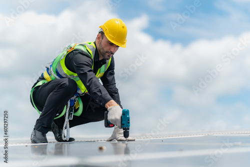 Professional specialist technician engineer working to maintenance checking and installing solar roof panel on the factory rooftop under sunlight. Worker inspection team for smart grid ecology energy