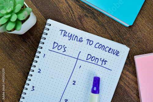 Concept of Trying to Conceive Do's and Don'ts write on book isolated on Wooden Table.