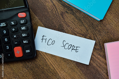 Concept of Fico Score write on sticky notes isolated on Wooden Table. photo